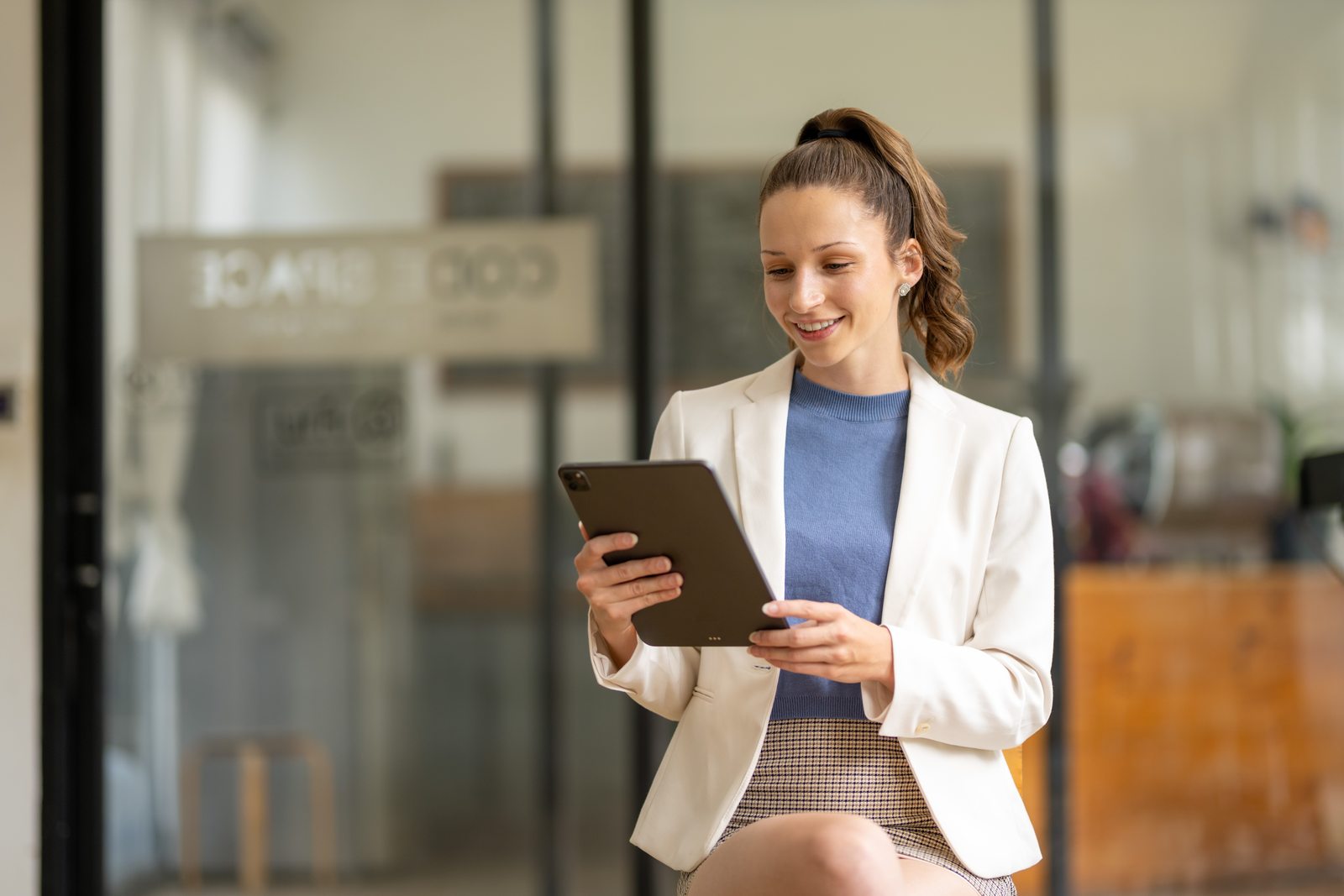 Professional using a tablet at work; illustrative photography