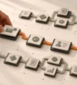 A hand selecting a simple route between miniature business task cards on an ivory tabletop.