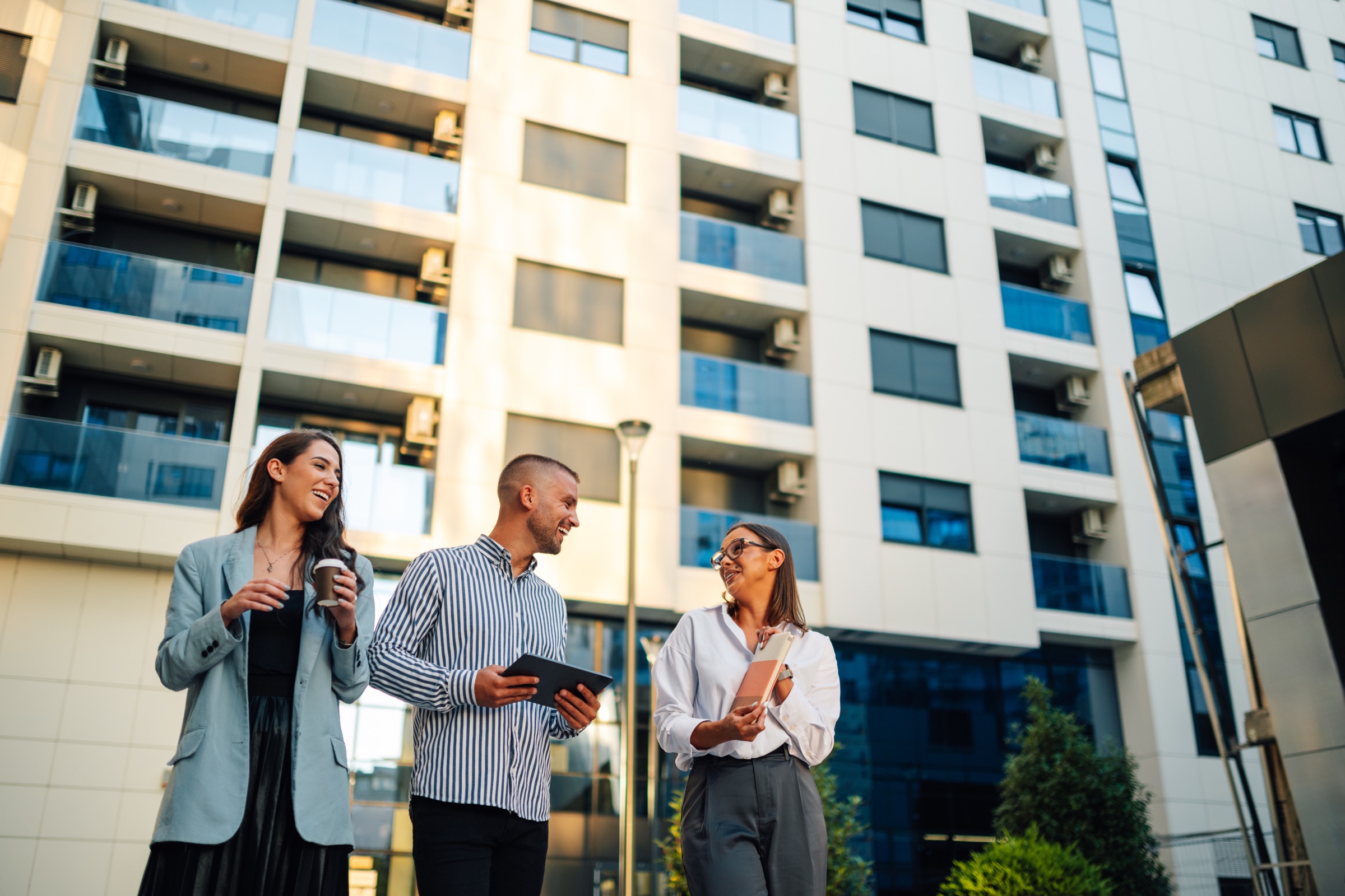Property professionals outside a modern building; illustrative stock photograph