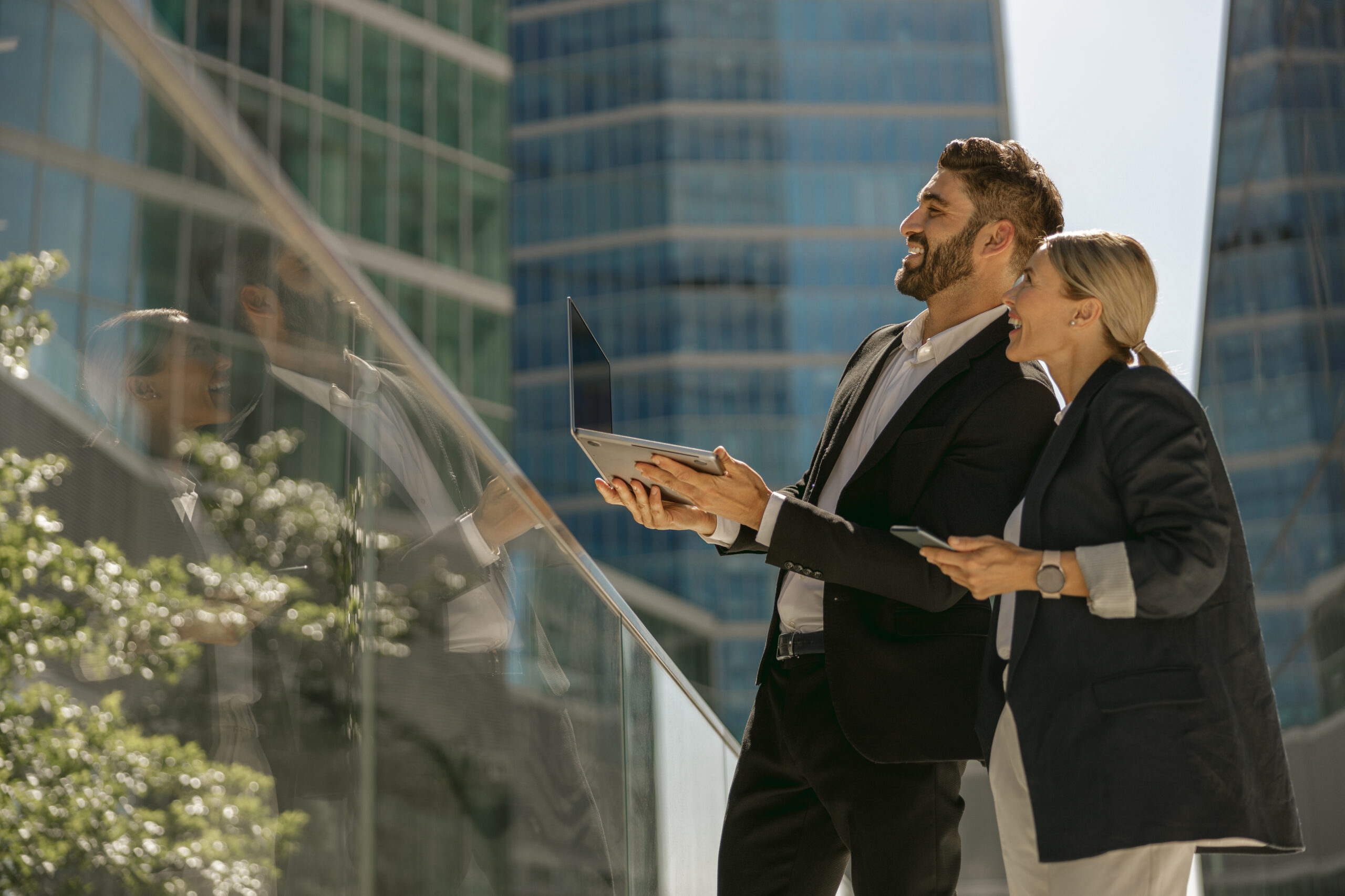 Property professionals reviewing a commercial building with a laptop and tablet